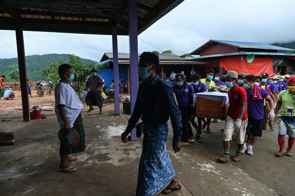A coffin containing the body of miner Than Naing is carried on July 4 before his funeral ceremony in Kachin State. (AFP)