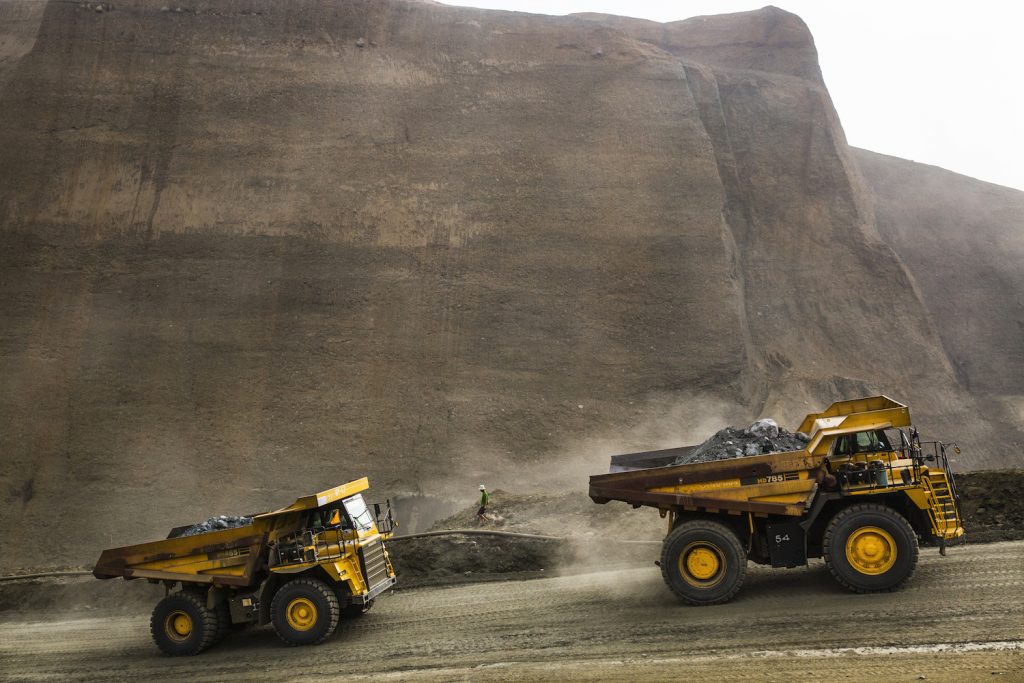 Dump trucks carry waste from a company mining site in Hpakant Township on May 21, 2019. (Hkun Lat | Frontier)