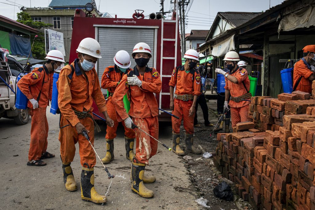 Firefighters prepare to disinfect a market in Mrauk-U as COVID-19 cases surge in the north of the state. (Hkun Lat I Frontier)