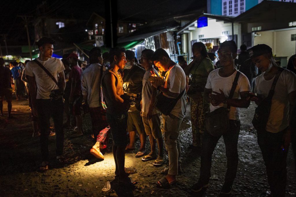 Jade buyers use flashlights to determine the value of stones at Hpakant Township's Lunghkang jade market on July 15, 2020. (Hkun Lat | Frontier)